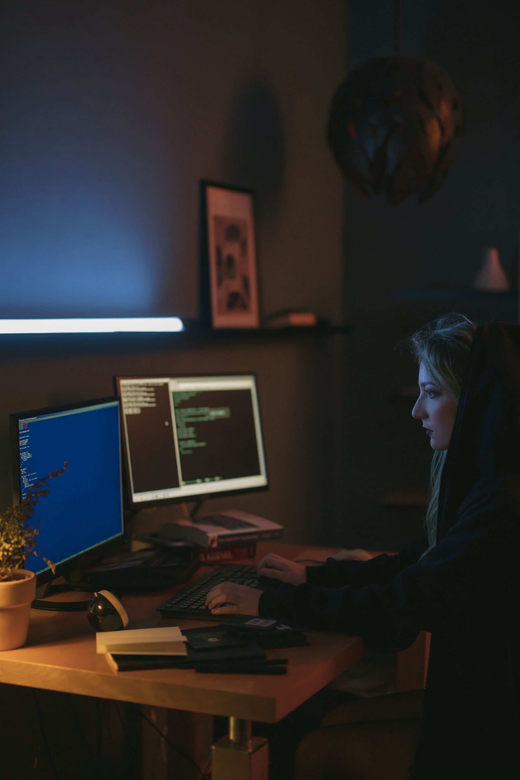 Engineer reviewing cybersecurity alerts on dual monitors