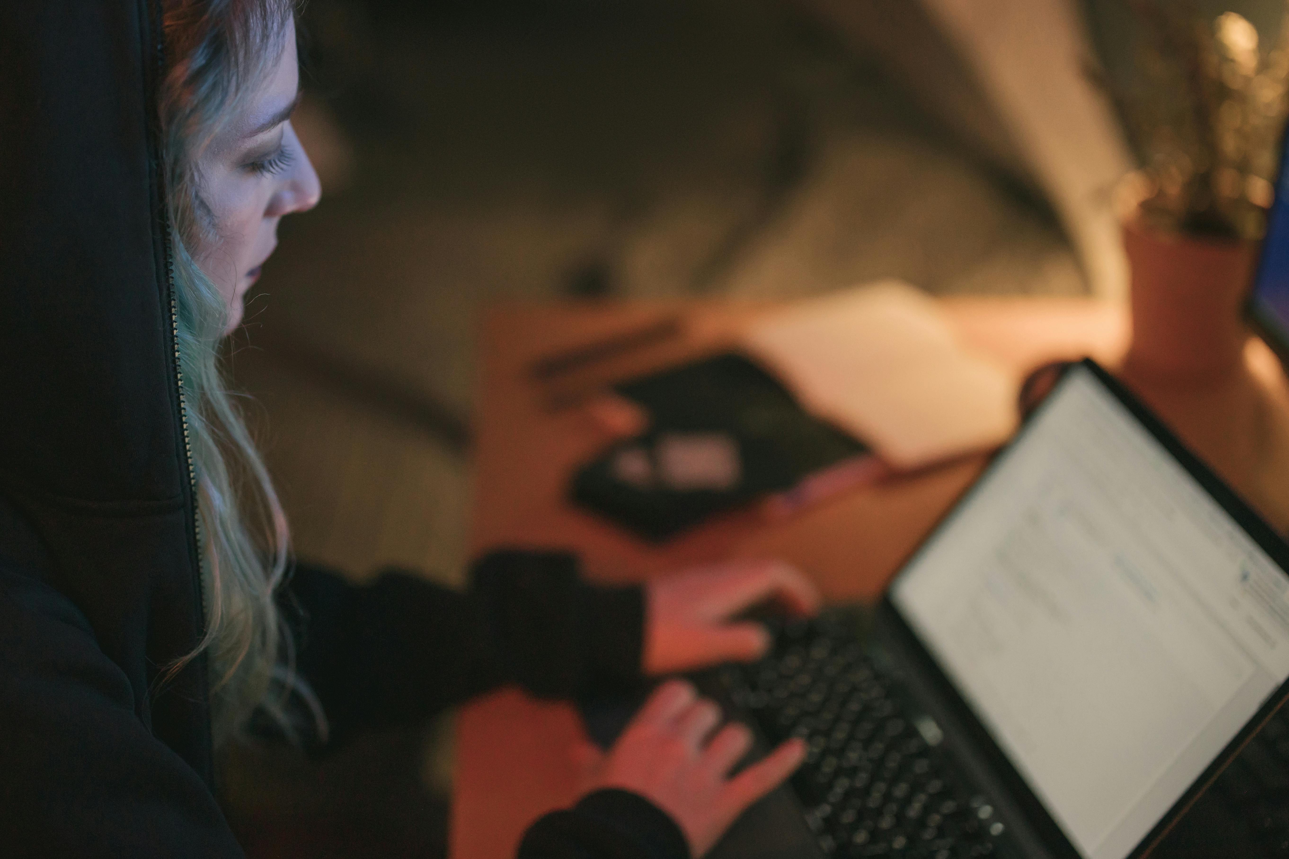 woman in black long sleeve shirt using black laptop computer