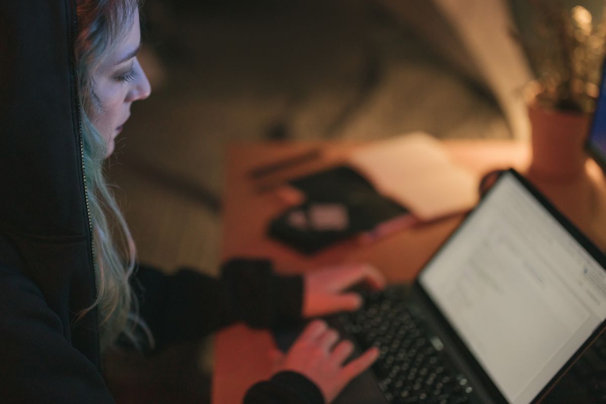 Adults in a cyber awareness session using laptops together