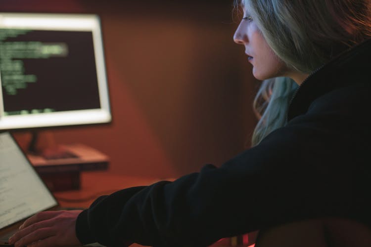 Woman In Black Hoodie Using A Laptop