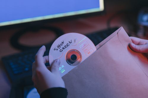 Free Close-Up Photo of Person Holding a Compact Disc Stock Photo