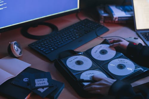 Person Holding CDs