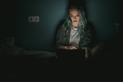 Woman Using a Laptop in the Dark