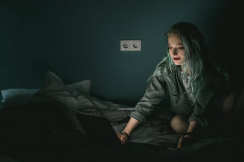 Woman Using Laptop in the Dark