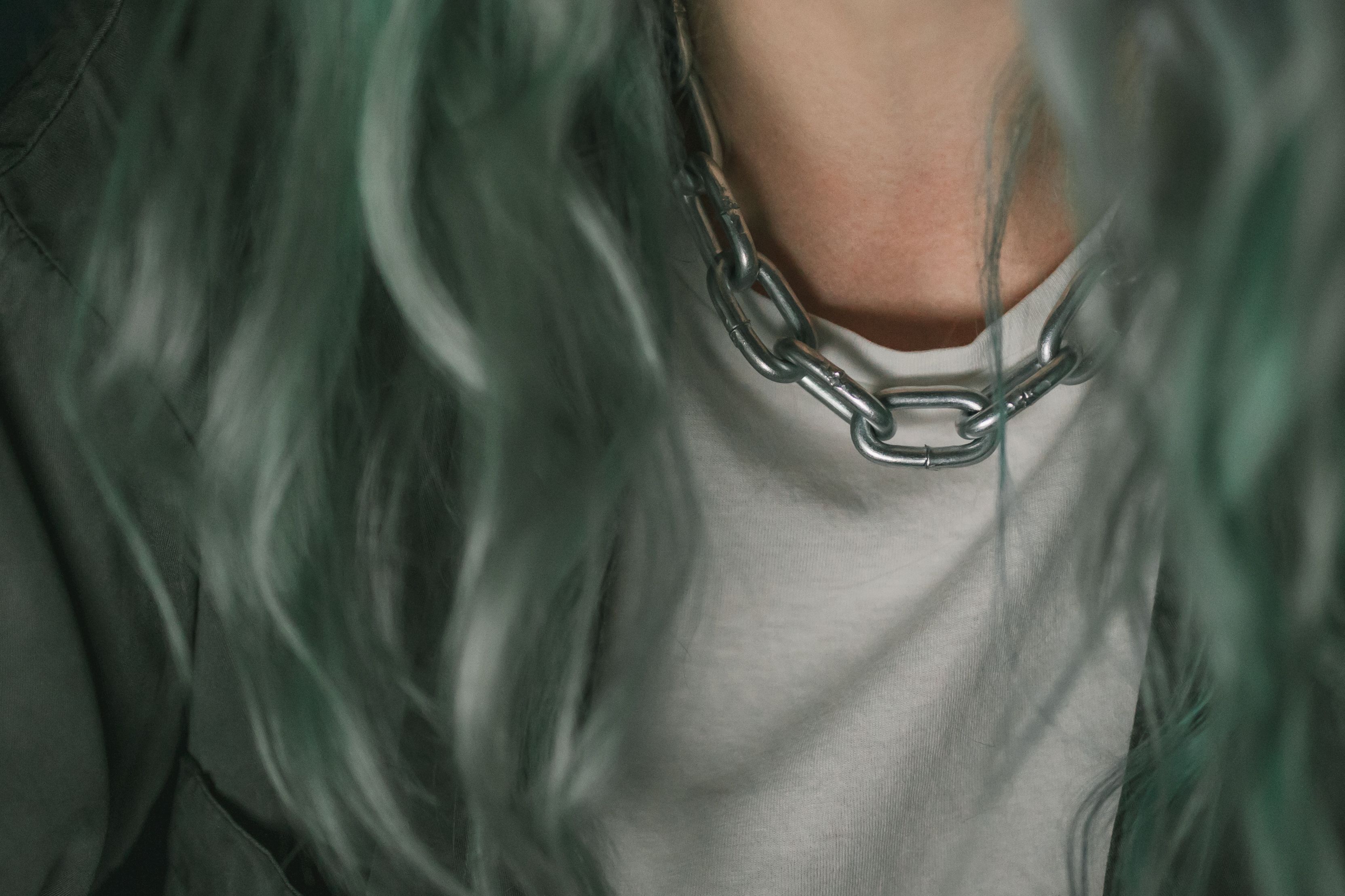 Contemporary silver chain necklace worn with a simple top