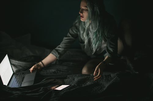 Woman Using Laptop in the Dark