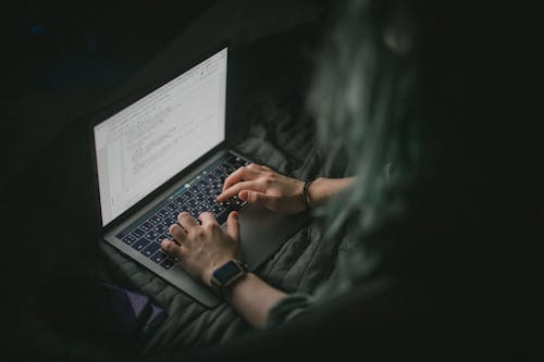 Free Person Typing on Laptop Stock Photo