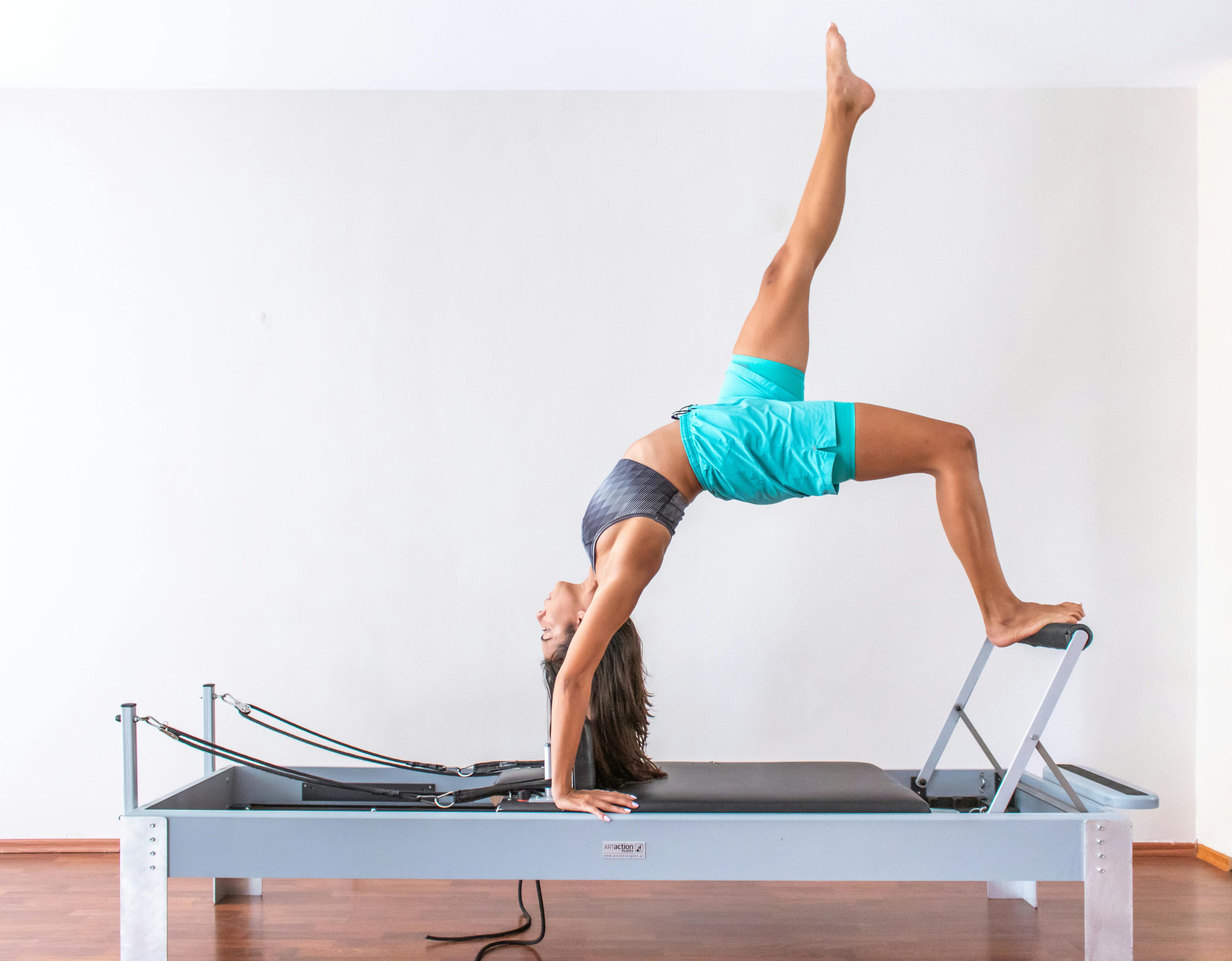 Pilates reformer woman short box side stretch exercise wrkout Stock Photo -  Alamy