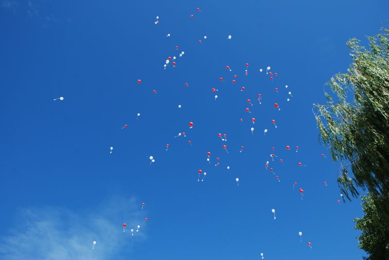 Balloons rising into the sky above a celebration, echoing the Gibraltar National Day balloon release