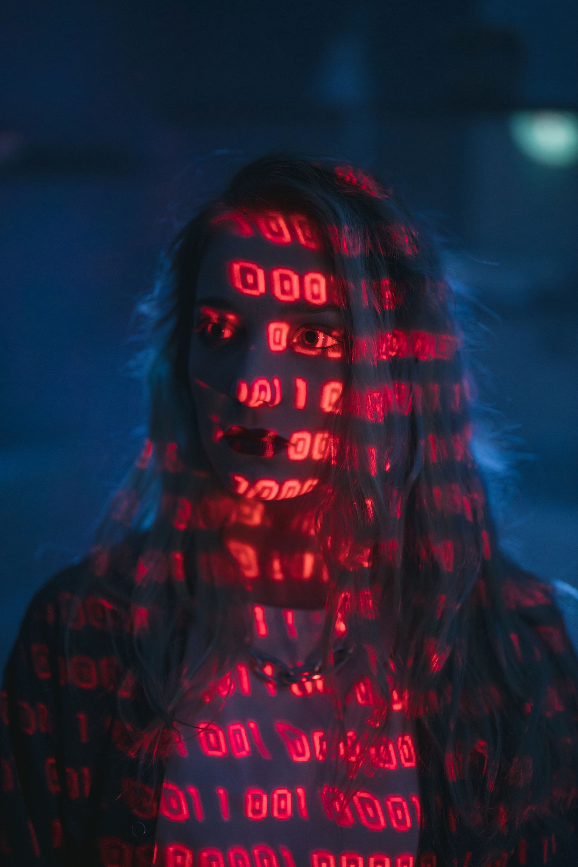 Woman with binary code projected on her face