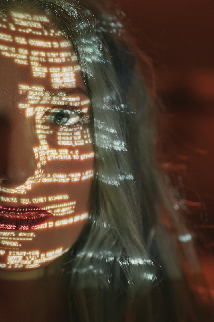 Woman With Text Projected On Her Face