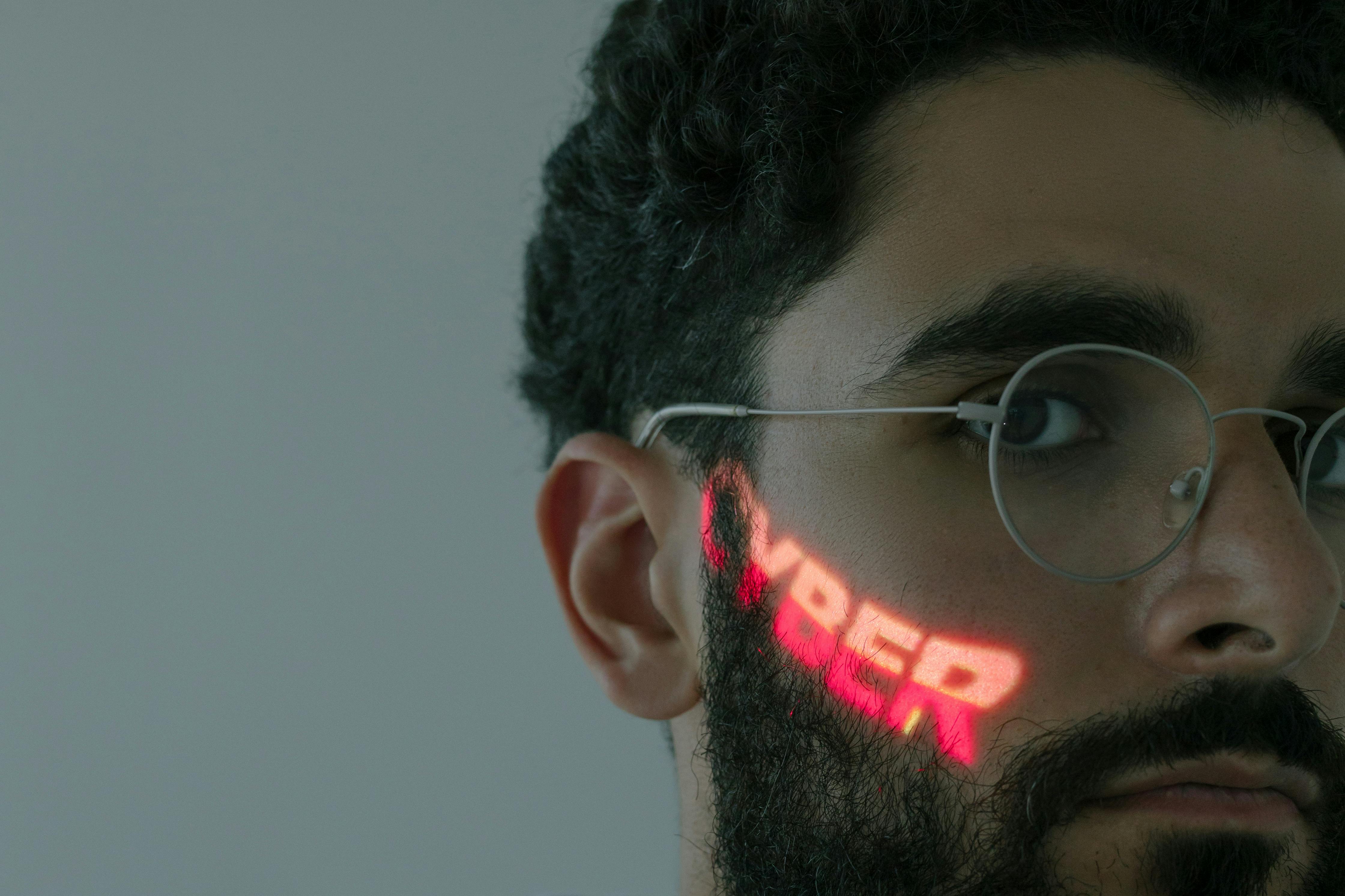 man in white framed eyeglasses while looking at the camera