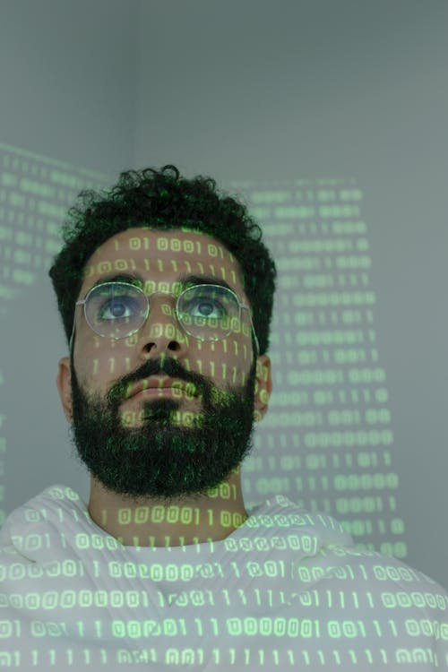 Free Man With Binary Code Projected on His Face Stock Photo