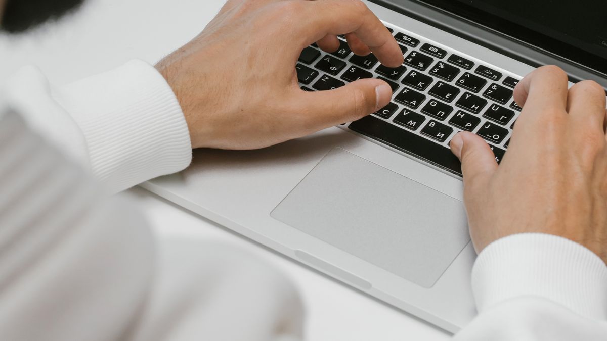 Developer modeling AI SaaS LLM spend and launch costs on a laptop