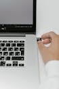 Hand Putting a USB Flash Drive in a Laptop