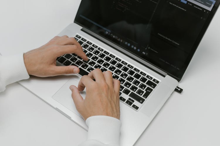 Hands On A Laptop Keyboard