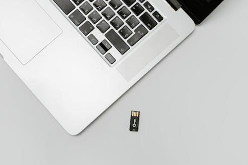 Free A Memory Card Near a Laptop Stock Photo