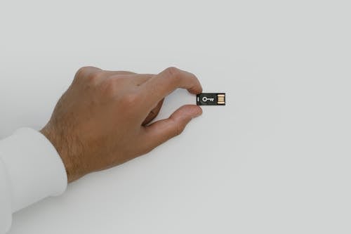 Free Hand Holding a USB Flash Drive Stock Photo