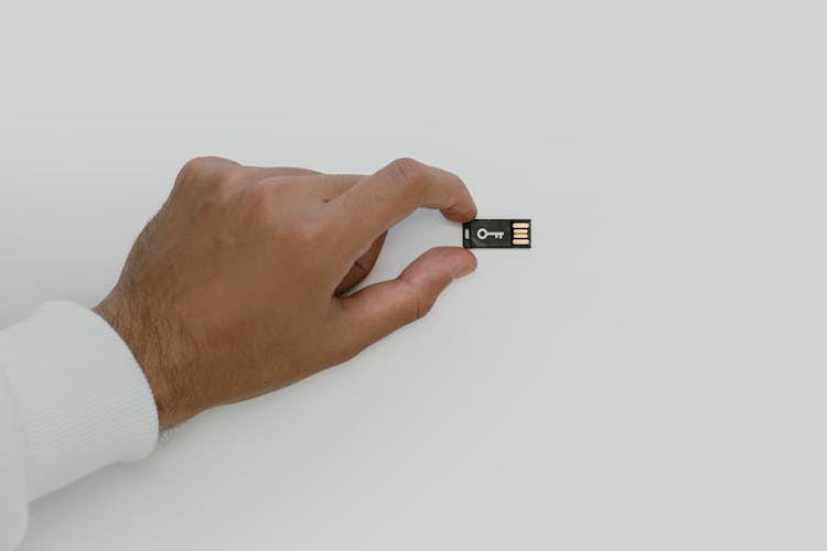 Hand Holding A USB Flash Drive