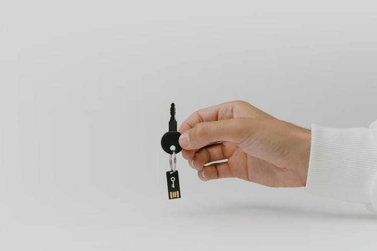 Photo Of Person Holding A Black Key