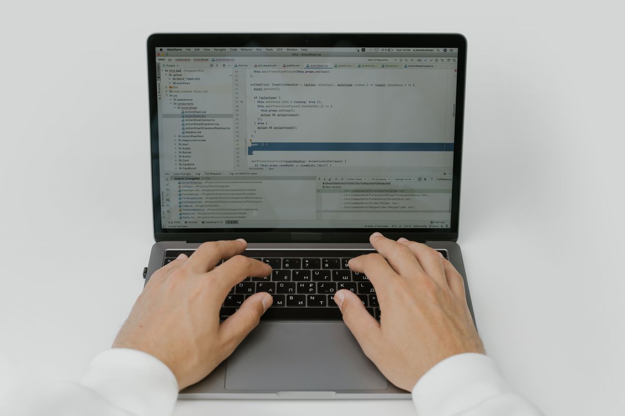 Hands coding on a laptop