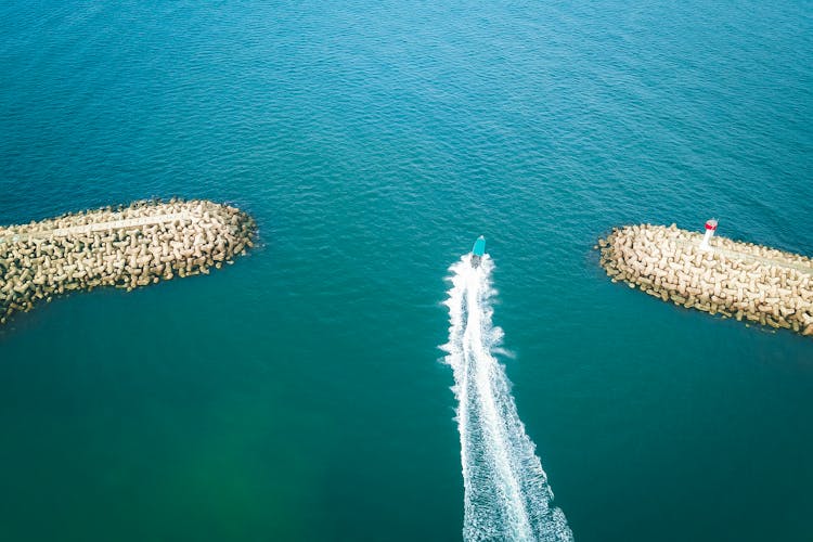 Boat Floating And Leaving Foaming Trail In Sea