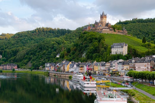 Idyllic landscape of Cochem Castle overlooking Moselle River in Germany. by Kai Pilger