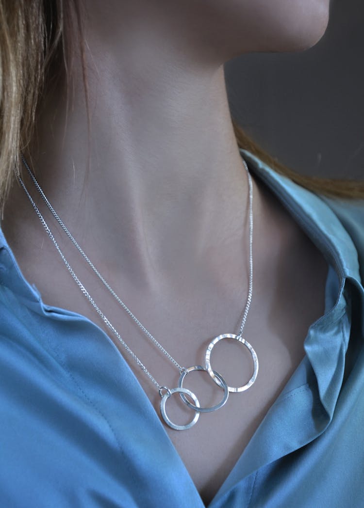 Close-up Of Silver Necklace On Woman Neck