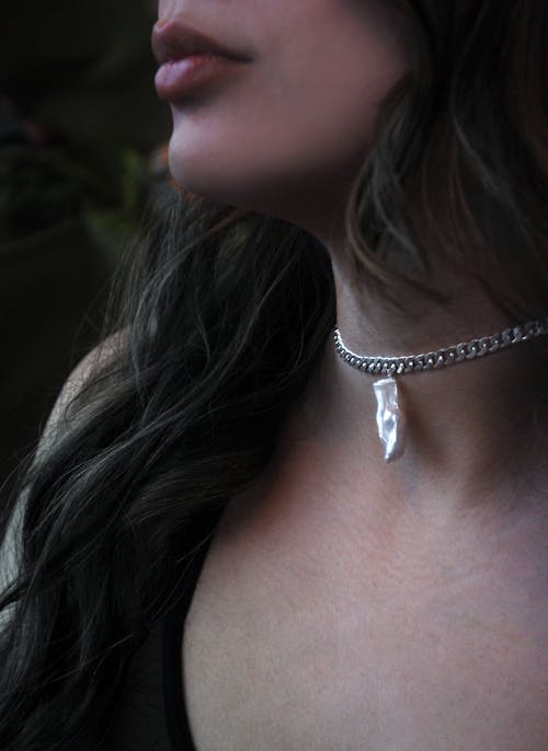 A Woman Wearing Silver Necklace