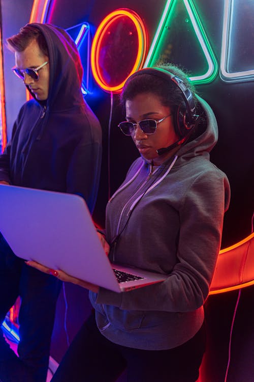 A Woman in Gray Hoodie Using a Laptop