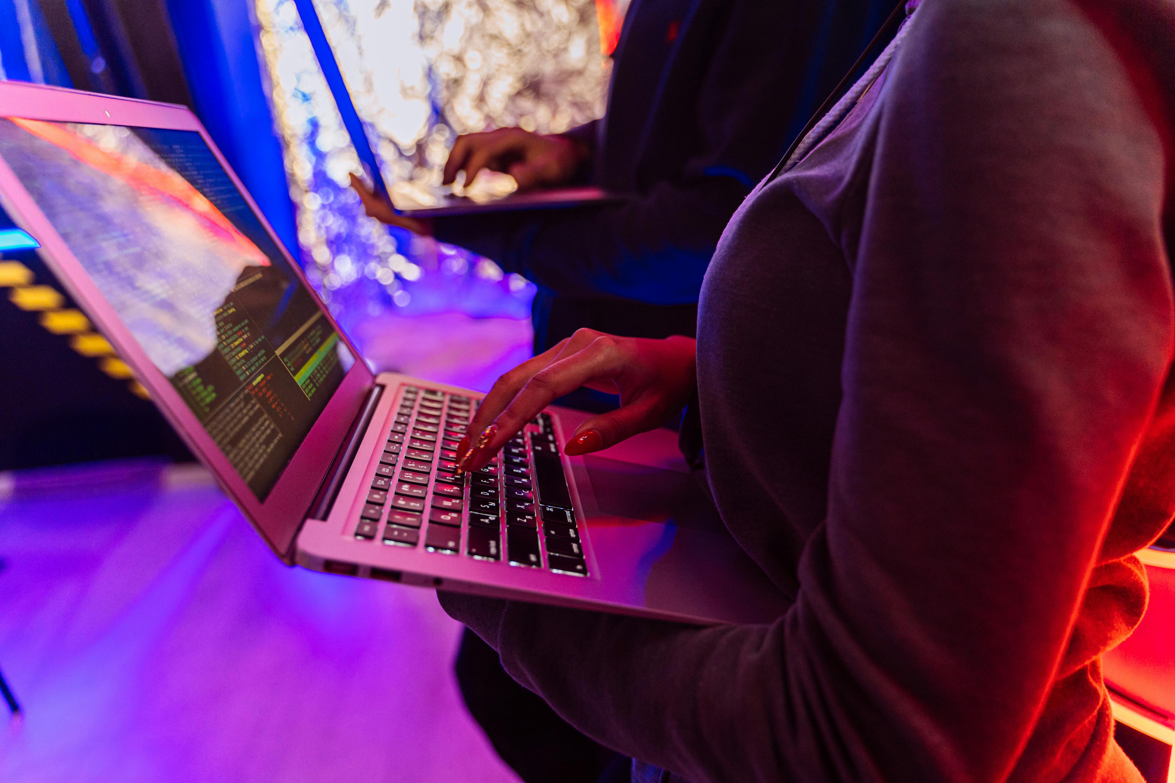 person in black long sleeve shirt using macbook pro