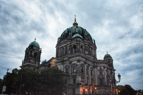 Free A majestic view of the Berlin Cathedral with intricate architecture under a dramatic cloudy sky. Stock Photo