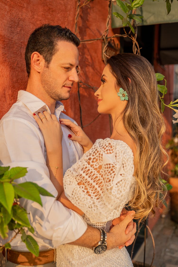 Stylish Newlywed Couple Embracing Near Street Wall