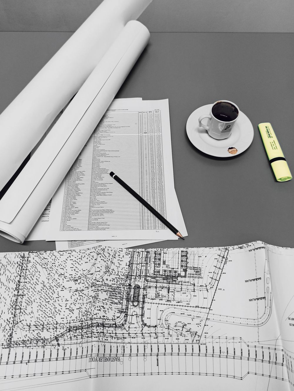 An architect sketching a plan beside a physical model
