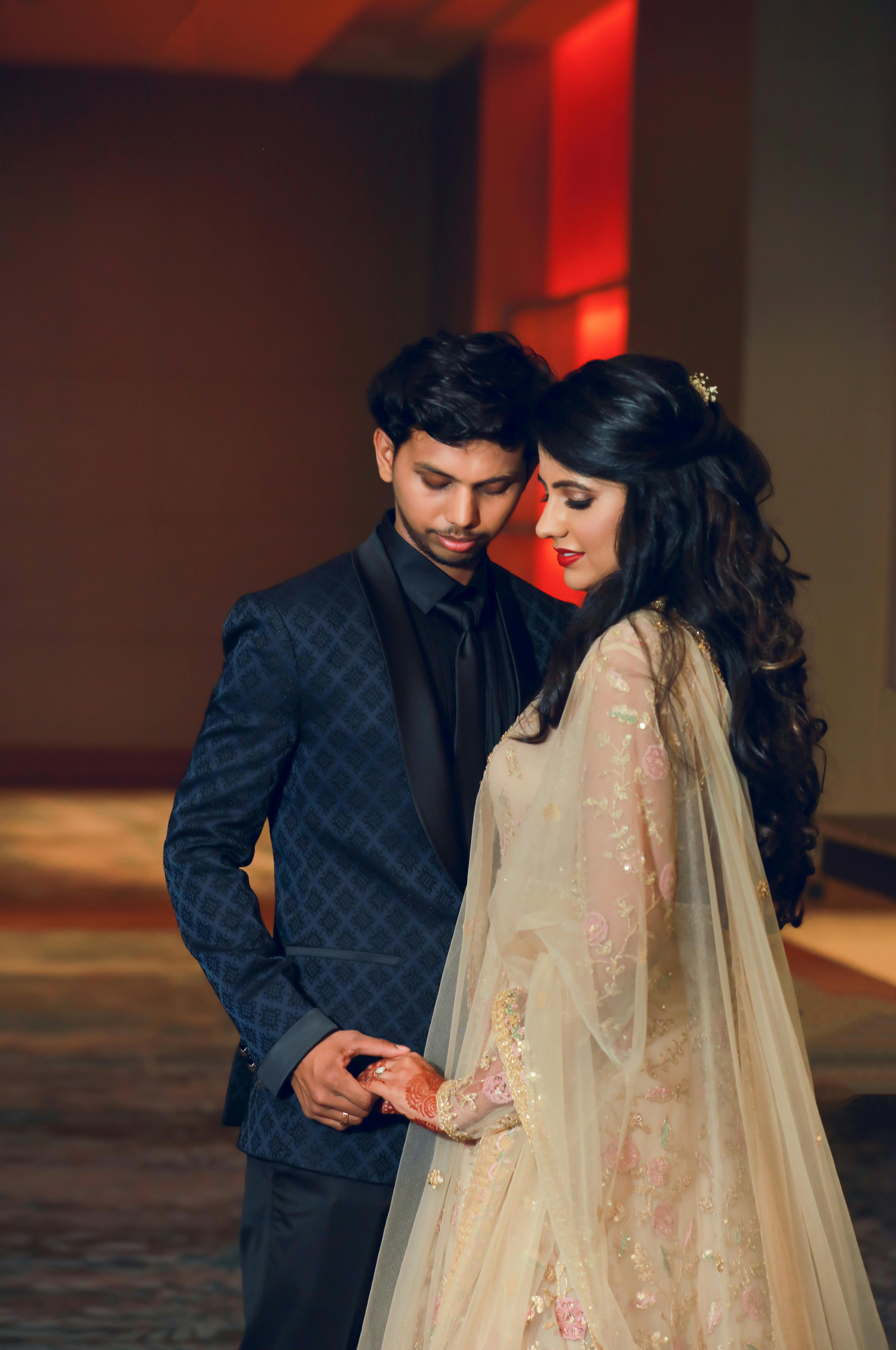 Candid Couple Shot - Bride in a Lehenga and Groom in a Traditional Suit. |  Wedding couple poses, Muslim wedding photography, Indian wedding  photography poses