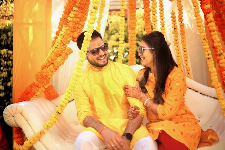 Bride And Groom Sitting Together And Smiling 