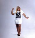 Cheerful confident plump black woman in white studio