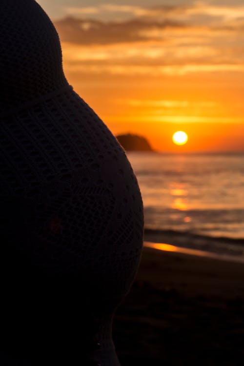 Close-up of Pregnant Woman on Beach on Sunset