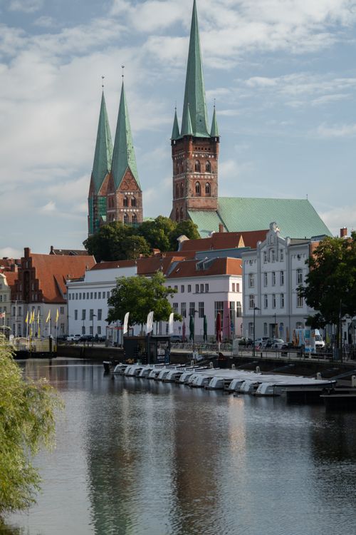 Free View of Lübeck Cathedral's gothic spires overlooking the Trave River in the old town of Lübeck, Germany. Stock Photo