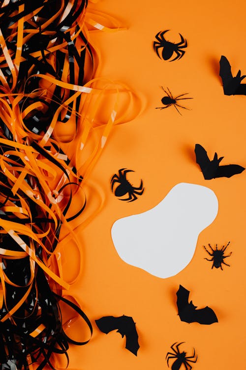 Paper Spiders and Bats on an Orange Background