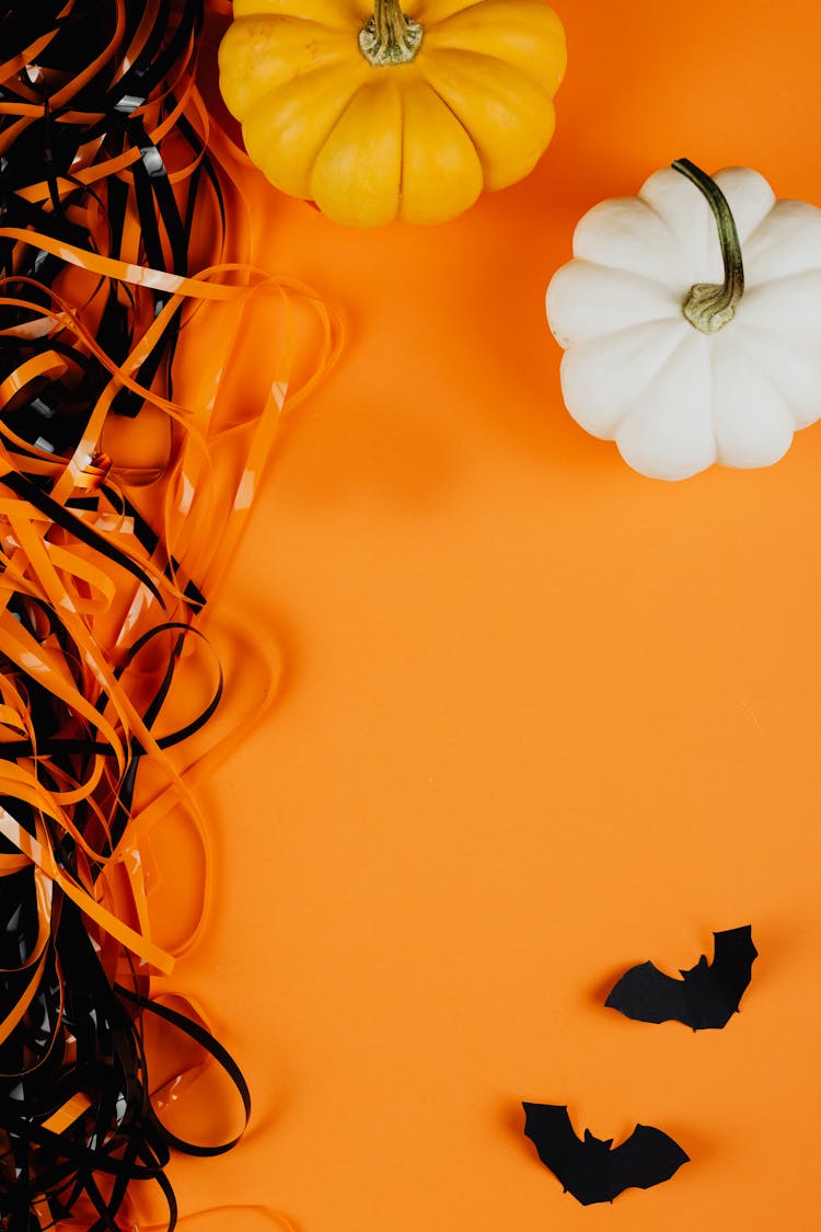 Pumpkins And Bats On An Orange Background