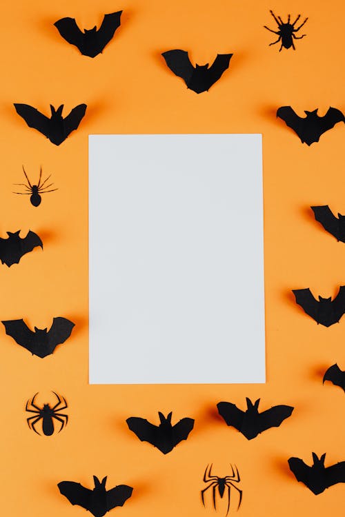 Paper Spiders and Bats on an Orange Background