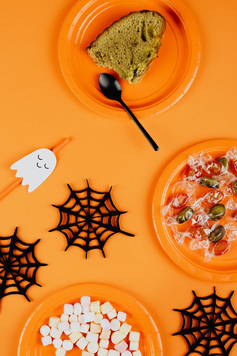 Halloween themed paper cups and tableware set on a table
