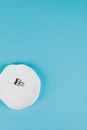 White Round Ornament on Blue Surface