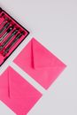 Pink Envelope With Green and White Pen