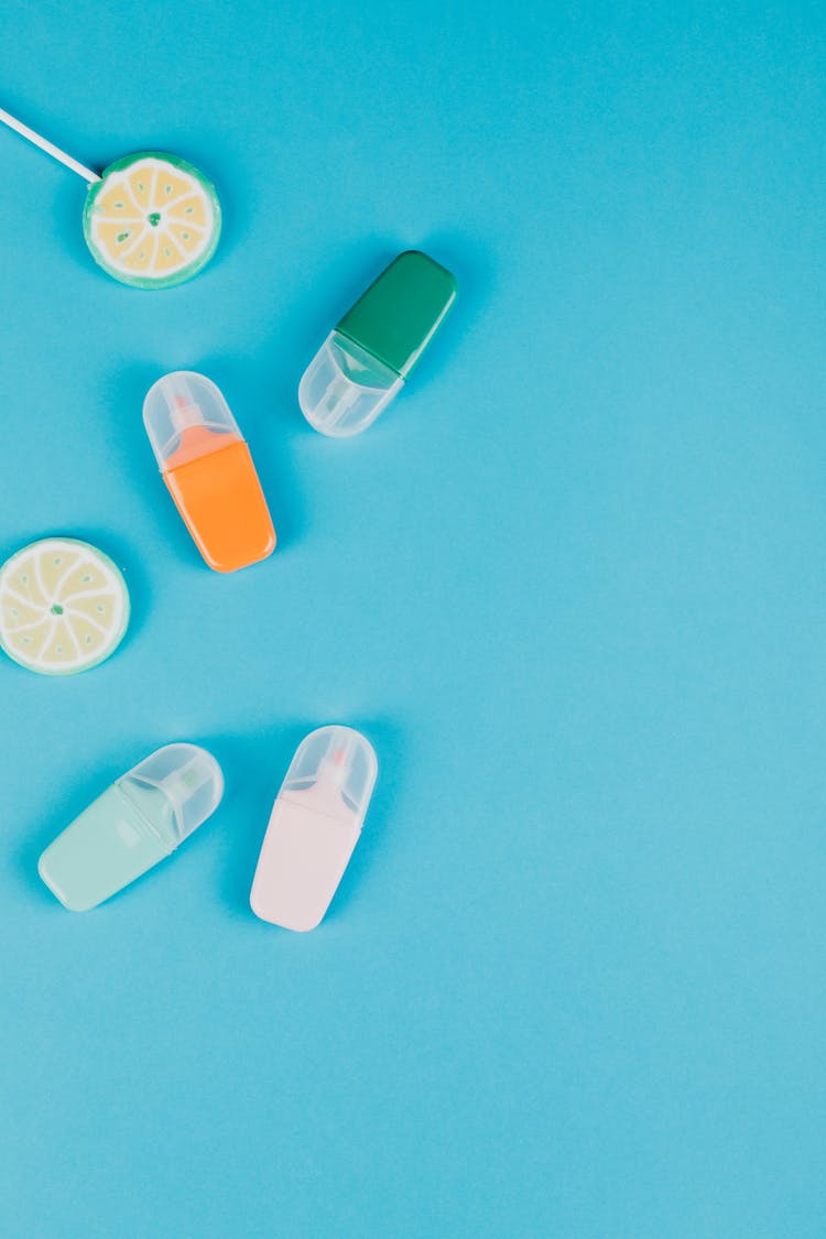 Highlighters And Lollipops On Blue Background