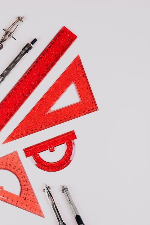 Red Rulers and Calipers on White Background