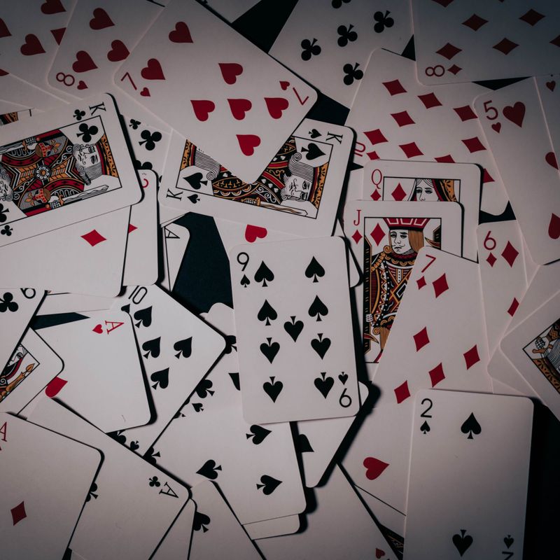 Playing cards scattered across a surface — photo by Aleksandar Dragojevic on Pexels