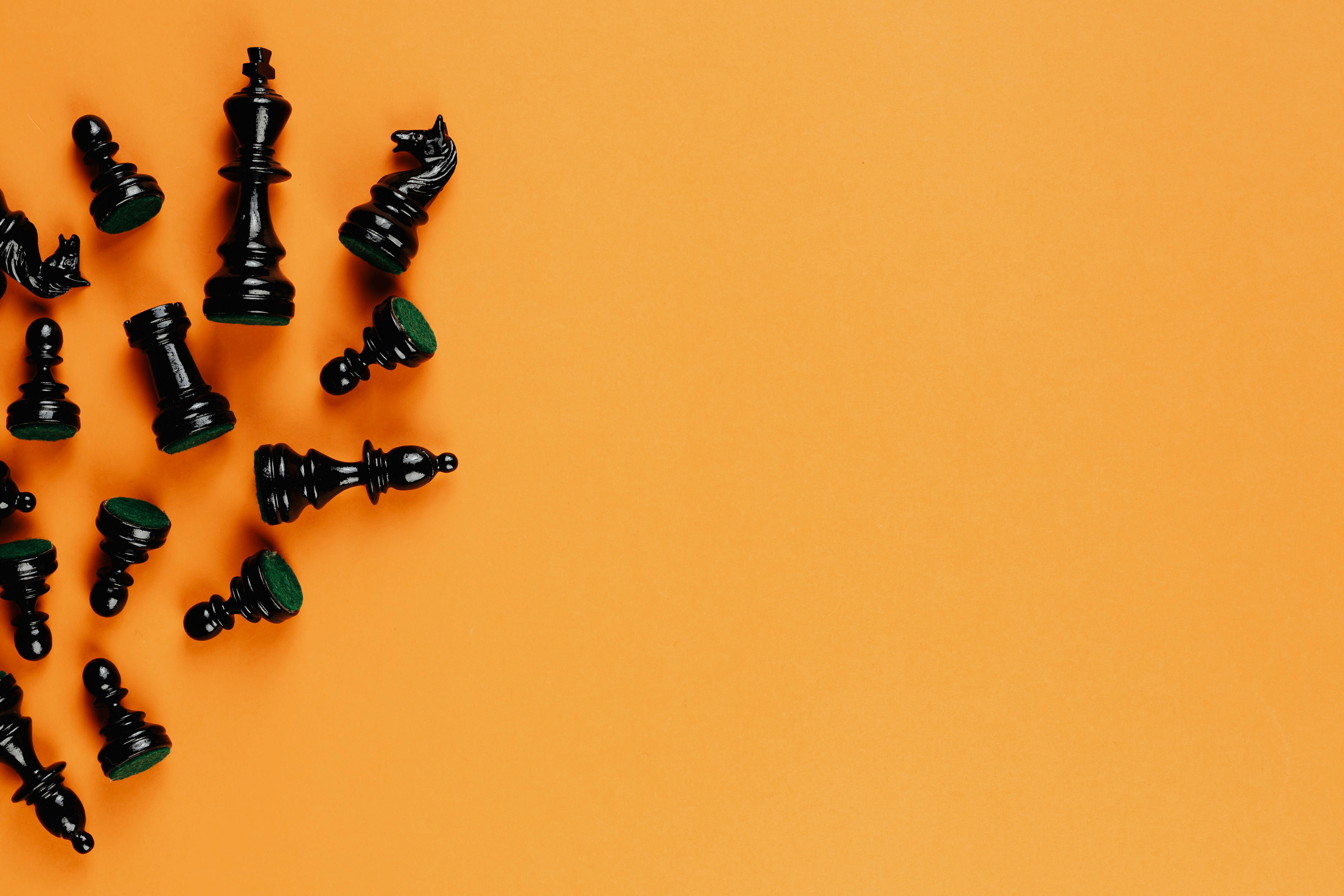 black chess pieces on yellow background