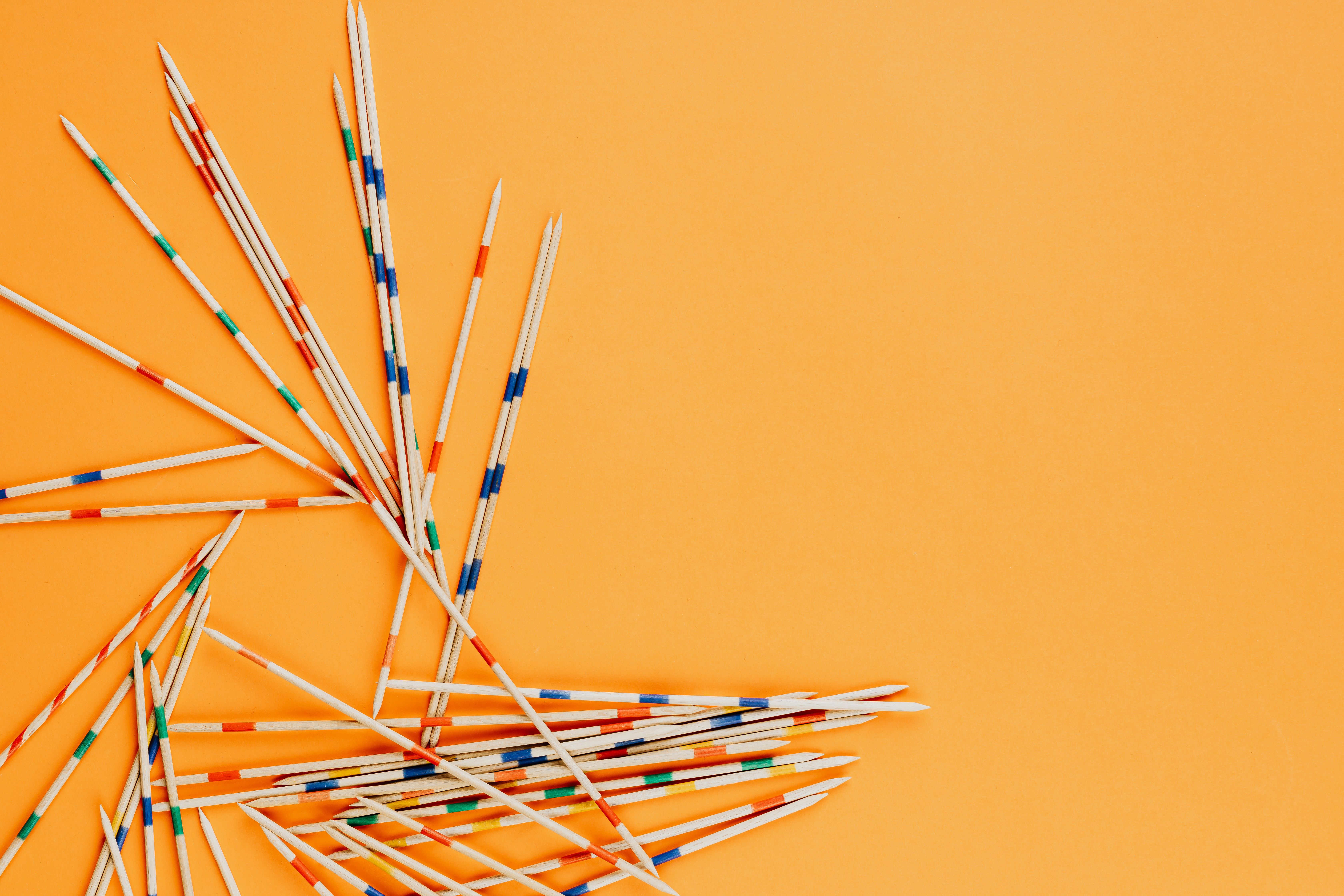 Blue and White Sticks on Yellow Metal Rack